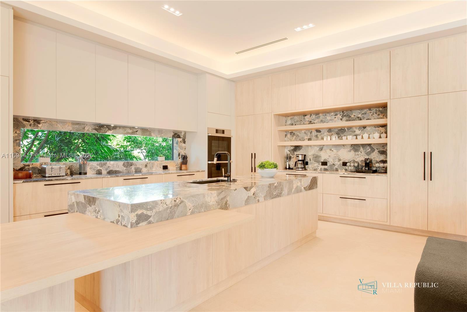 1200 Northeast 87th Street Miami, FL 33138 - Photo 11 of 58 a large white kitchen with stainless steel appliances cabinets and a counter top space