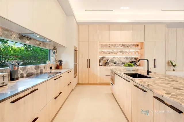 a large kitchen with stainless steel appliances kitchen island granite countertop a sink and cabinets