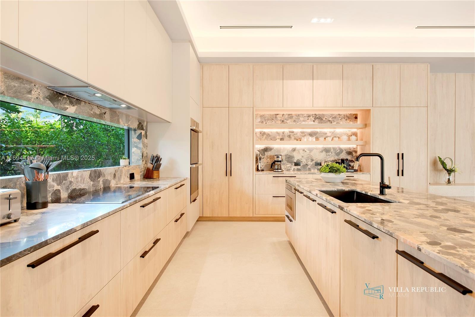 1200 Northeast 87th Street Miami, FL 33138 - Photo 12 of 58 a large kitchen with stainless steel appliances kitchen island granite countertop a sink and cabinets