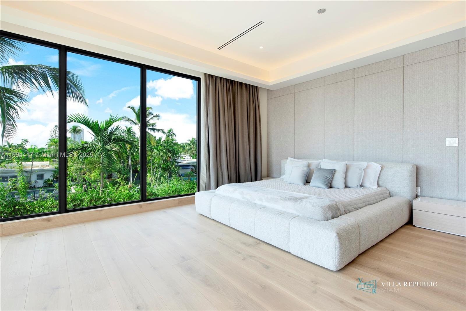 1200 Northeast 87th Street Miami, FL 33138 - Photo 26 of 58 a large white bed sitting in a room next to a window