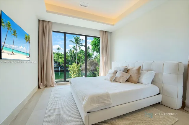 a bedroom with a bed and a large window