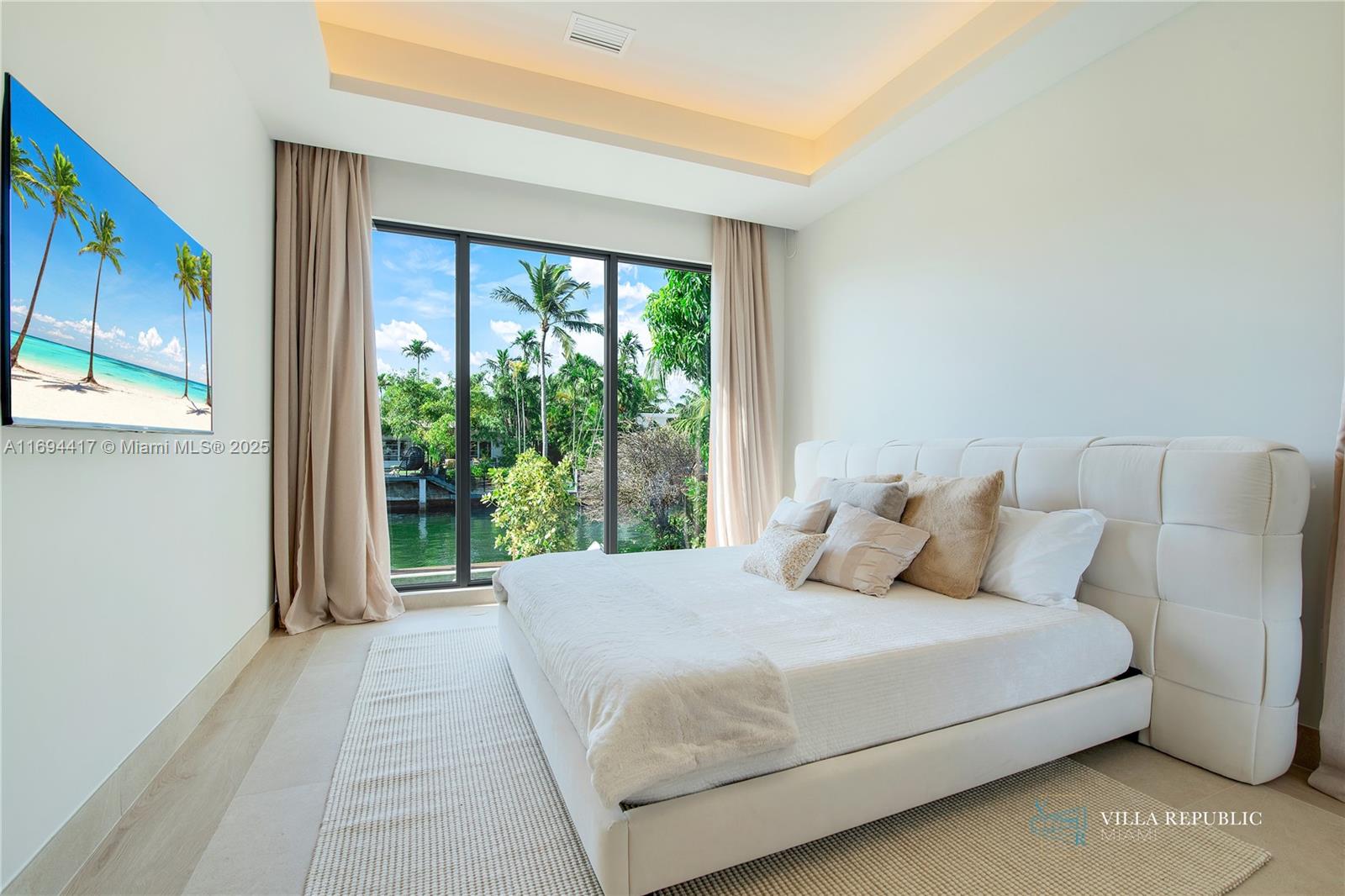 1200 Northeast 87th Street Miami, FL 33138 - Photo 37 of 58 a bedroom with a large bed and a large window