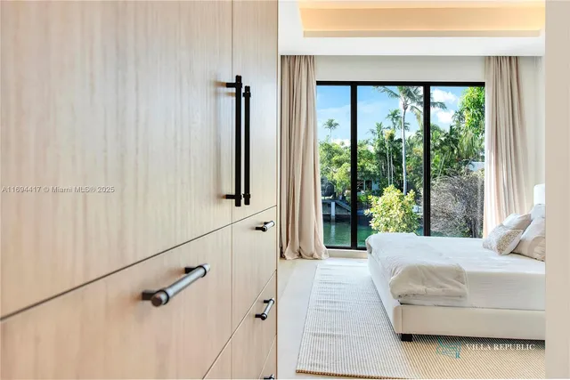 a bedroom with a bed window and potted plant
