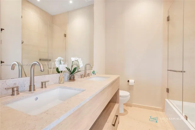 a bedroom with bed and a large window