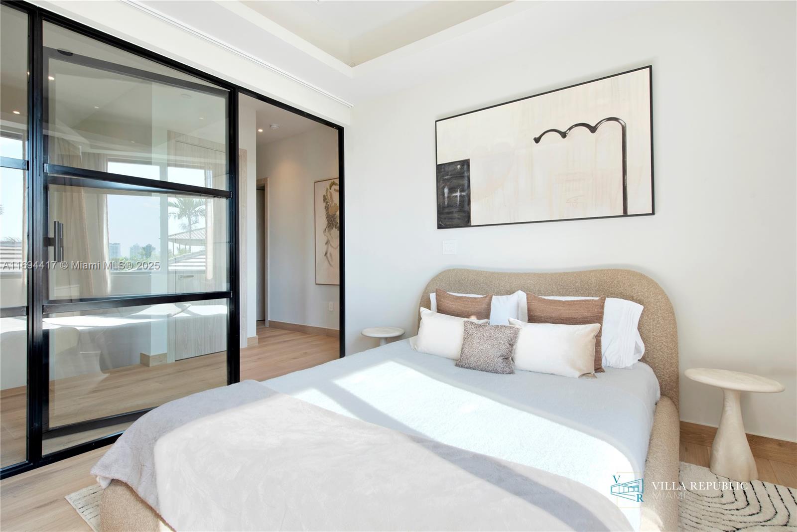 1200 Northeast 87th Street Miami, FL 33138 - Photo 50 of 58 a bedroom with a large bed and a painting on the wall