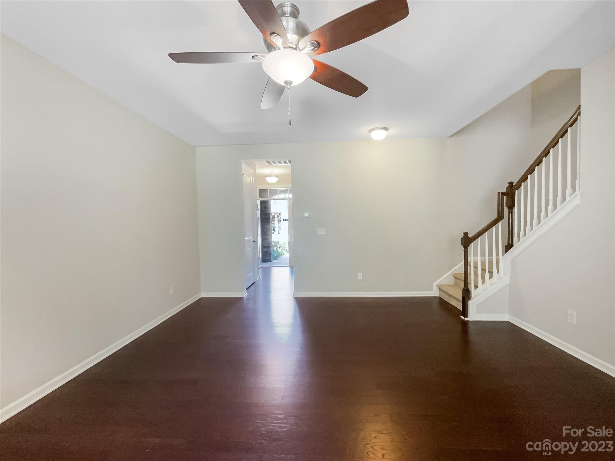 1004 Archibald Avenue Fort Mill, SC 29708 - Photo 2 of 18 a view of an empty room with wooden floor and a ceiling fan