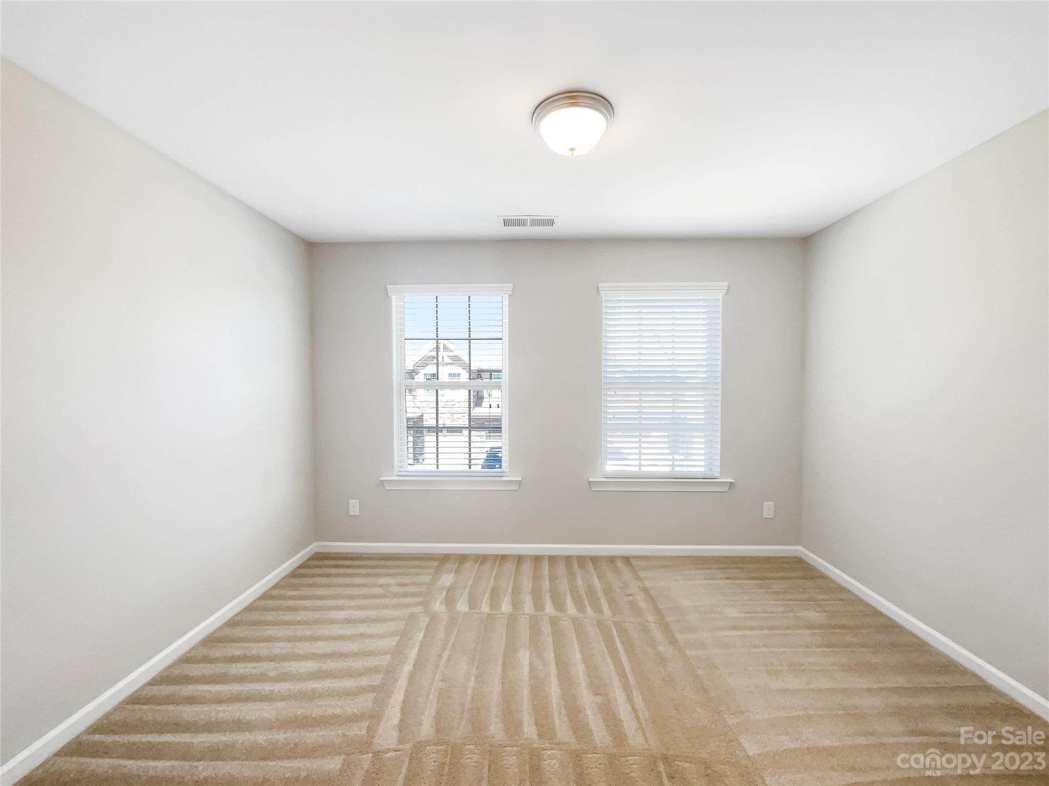 1004 Archibald Avenue Fort Mill, SC 29708 - Photo 3 of 18 an empty room with wooden floor and windows