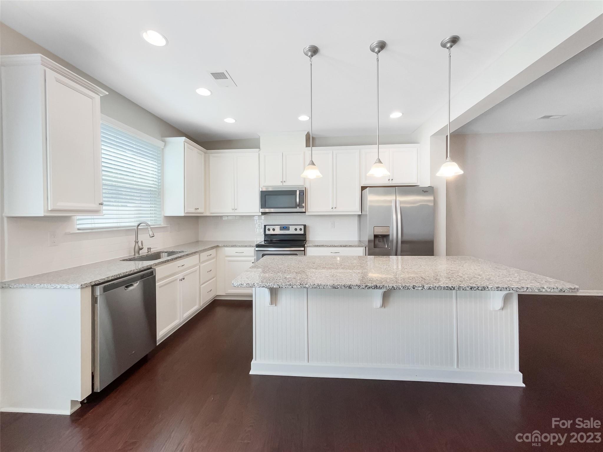 1004 Archibald Avenue Fort Mill, SC 29708 - Photo 4 of 18 a kitchen with stainless steel appliances granite countertop a sink a stove a refrigerator and white cabinets