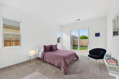 a spacious bedroom with a bed and a window
