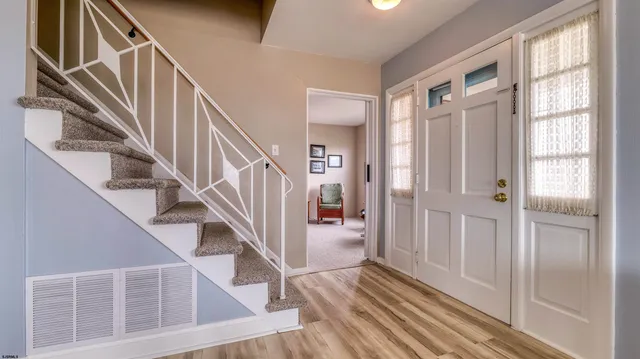 a view of entryway and hall with wooden floor