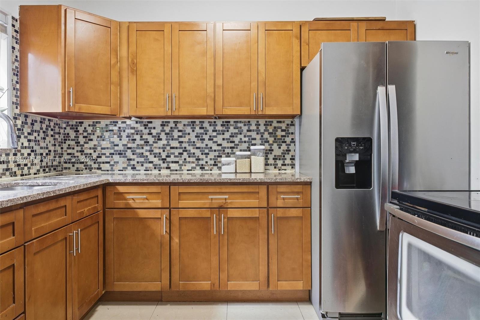 104 Southwest 40th Avenue Miami, FL 33134 - Photo 15 of 42 a kitchen with stainless steel appliances granite countertop a refrigerator and a sink