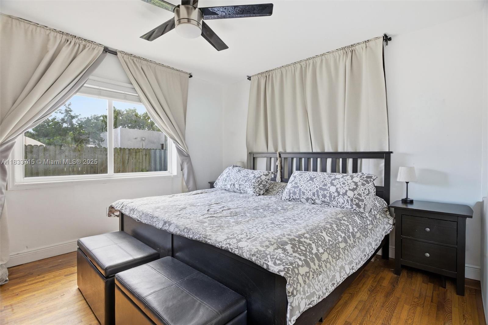 104 Southwest 40th Avenue Miami, FL 33134 - Photo 17 of 42 a bedroom with a bed window and wooden floor