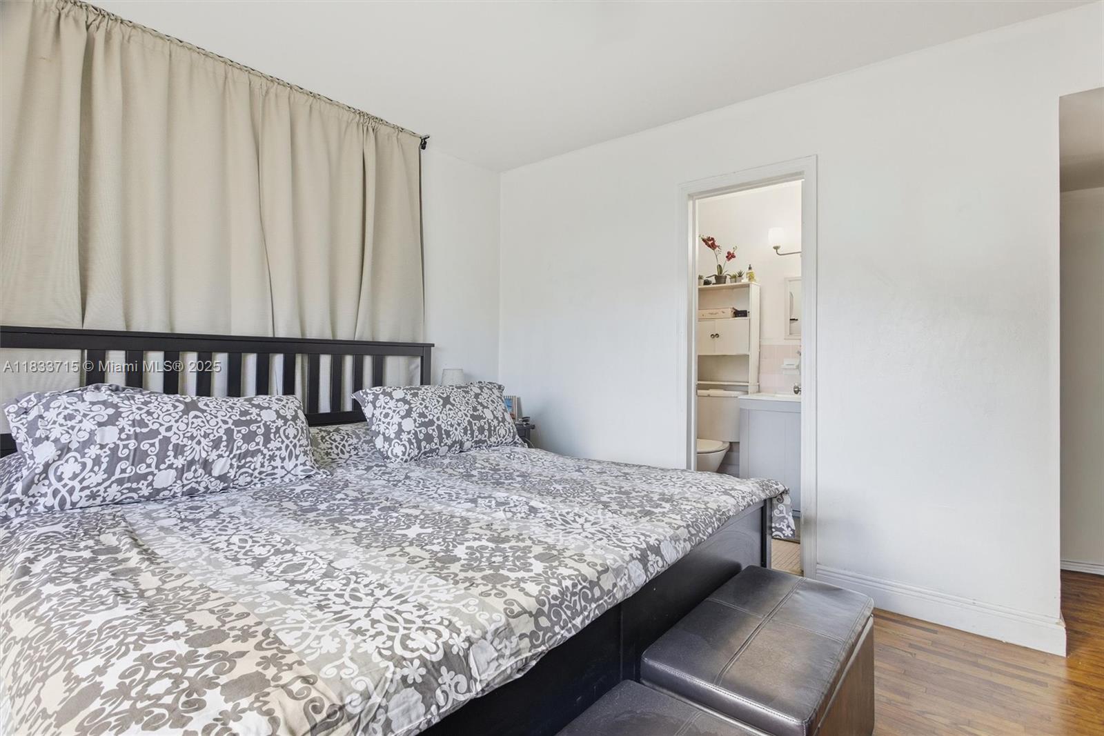 104 Southwest 40th Avenue Miami, FL 33134 - Photo 18 of 42 a bed sitting in a bedroom next to a window