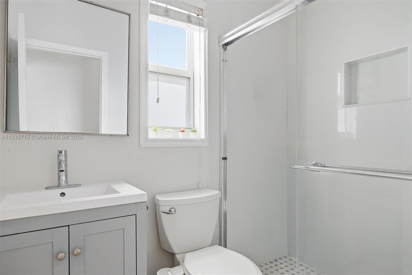 104 Southwest 40th Avenue Miami, FL 33134 - Photo 23 of 42 a bathroom with a toilet sink and mirror