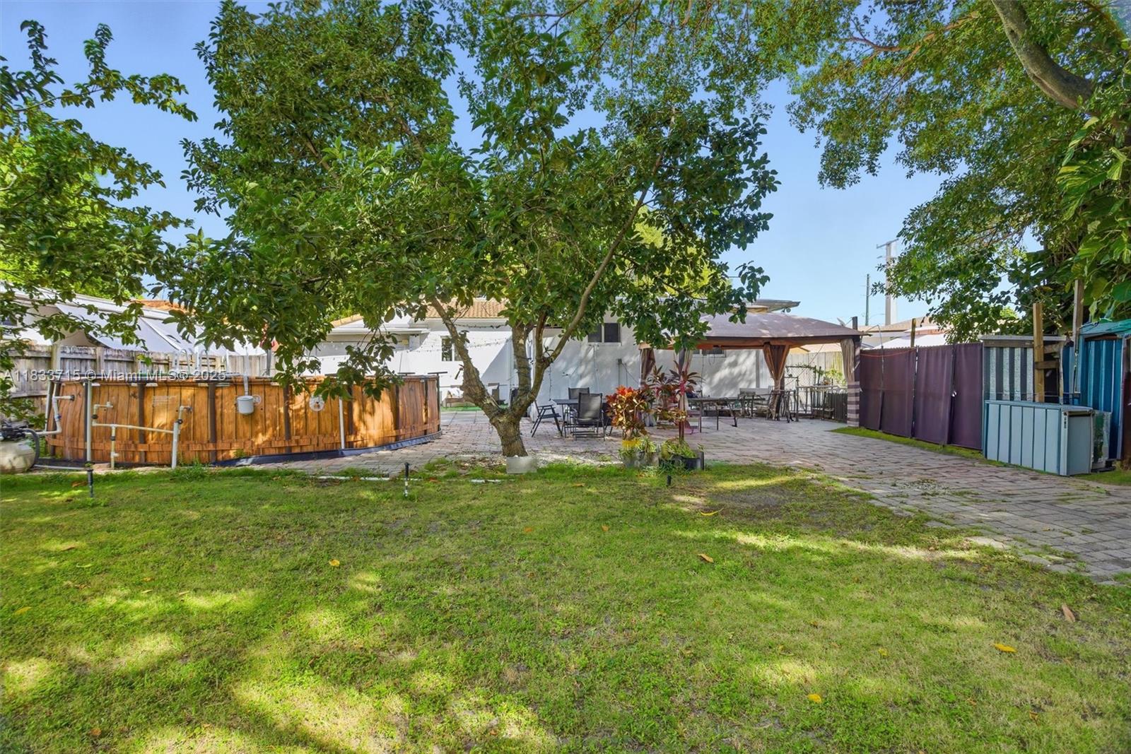 104 Southwest 40th Avenue Miami, FL 33134 - Photo 25 of 42 a view of a yard with a house and a large tree