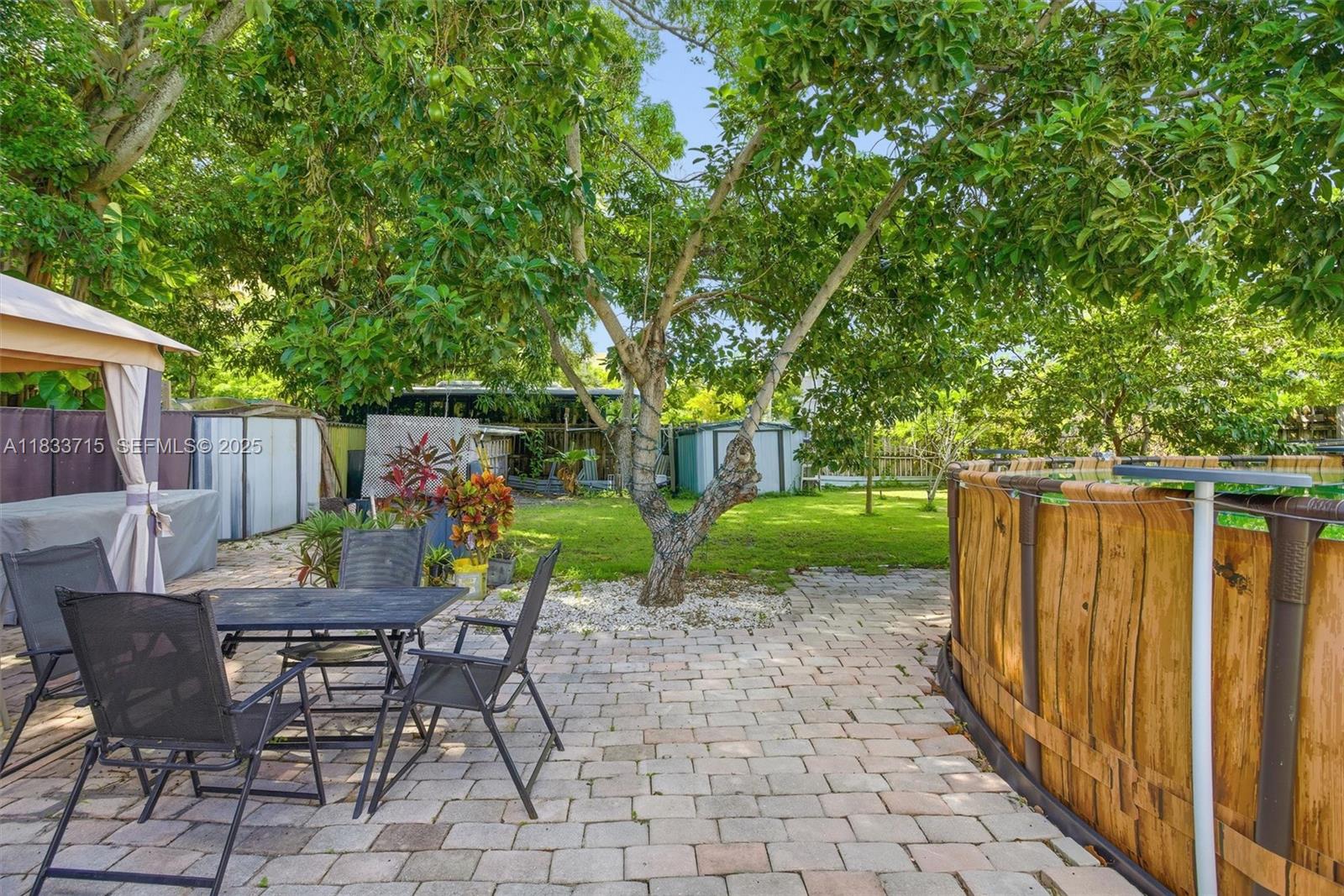104 Southwest 40th Avenue Miami, FL 33134 - Photo 25 of 43 a view of a chairs and table in backyard of the house