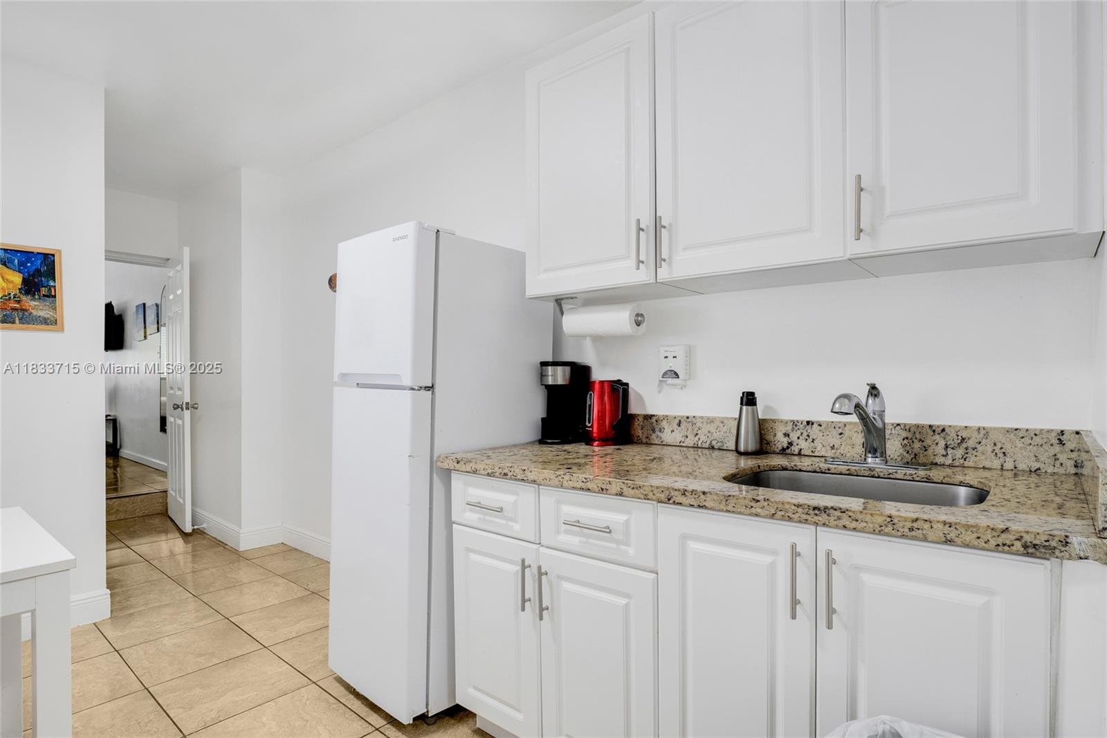104 Southwest 40th Avenue Miami, FL 33134 - Photo 30 of 42 a kitchen with stainless steel appliances granite countertop a refrigerator sink and cabinets