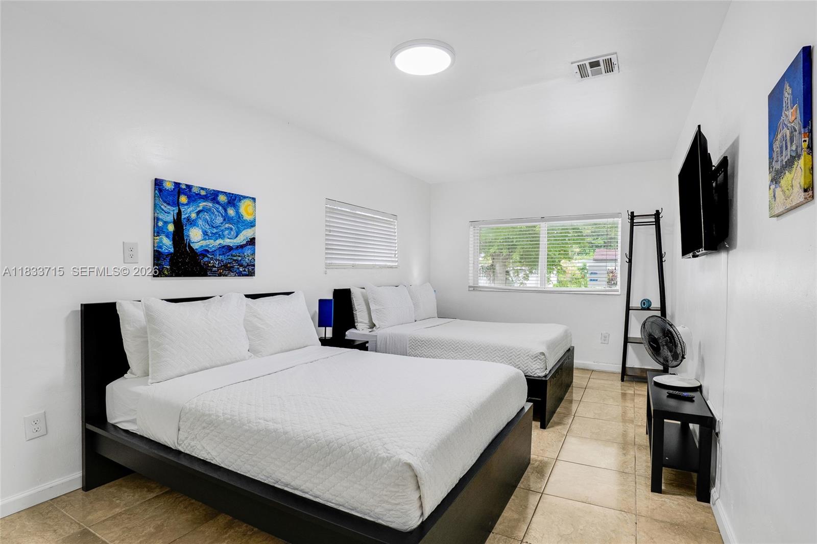 104 Southwest 40th Avenue Miami, FL 33134 - Photo 32 of 41 a bedroom with a bed and a flat tv screen on the dresser