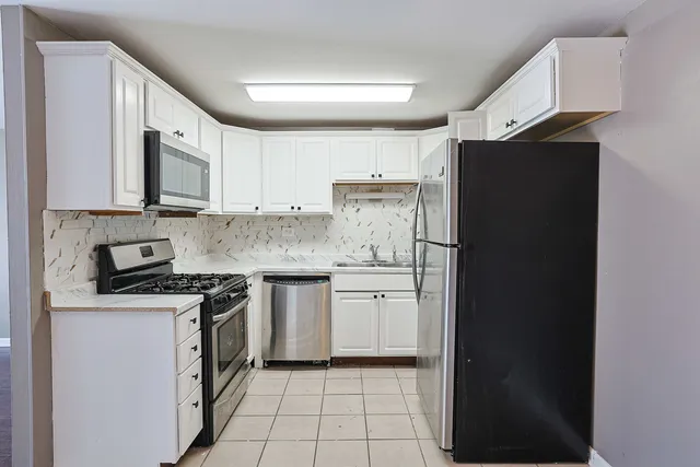 a kitchen with a refrigerator stove and sink