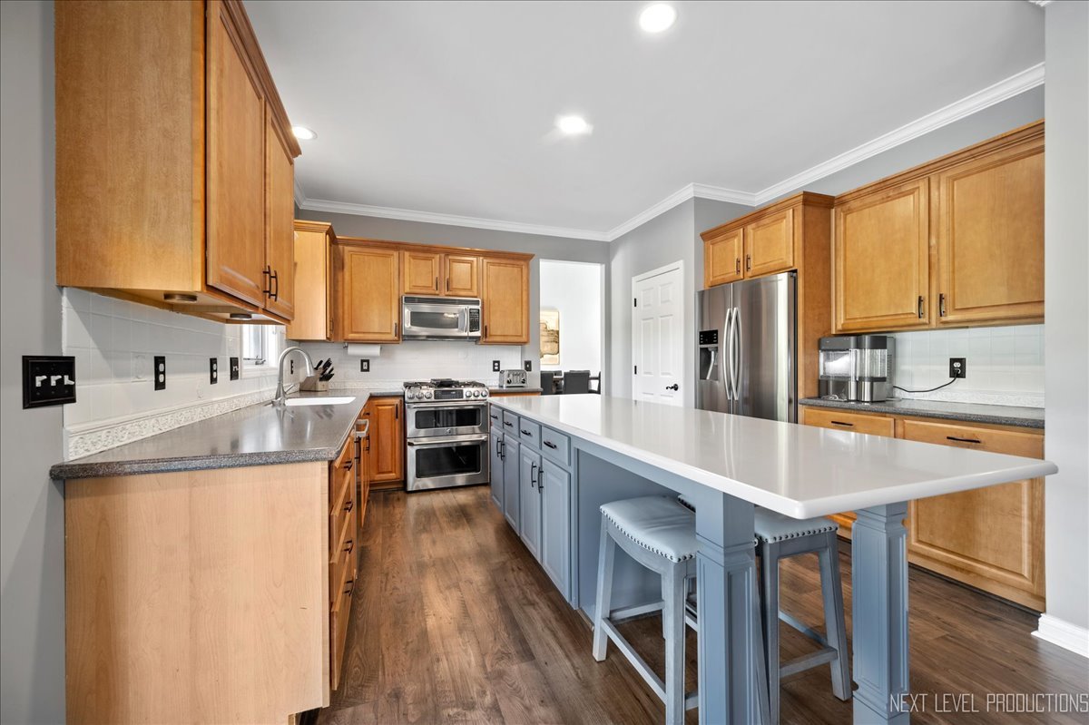 39W252 Bartelt Road Geneva, IL 60134 - Photo 12 of 34 a kitchen with stainless steel appliances granite countertop a stove top oven a sink dishwasher and a refrigerator