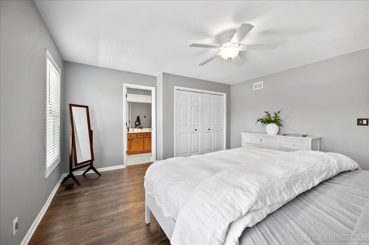 39W252 Bartelt Road Geneva, IL 60134 - Photo 16 of 34 a bedroom with a bed and a chandelier