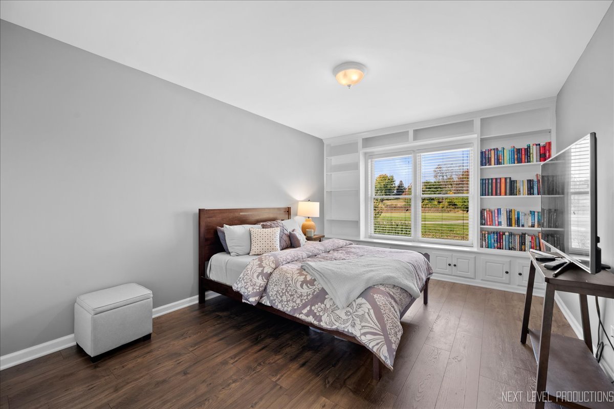39W252 Bartelt Road Geneva, IL 60134 - Photo 23 of 34 a bedroom with a bed and a book shelf