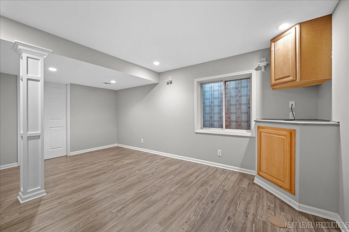 39W252 Bartelt Road Geneva, IL 60134 - Photo 26 of 34 an empty room with wooden floor and a window