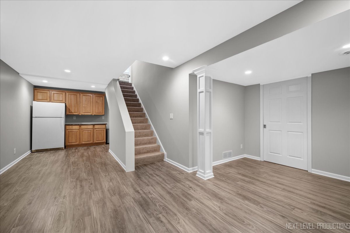39W252 Bartelt Road Geneva, IL 60134 - Photo 27 of 34 a view of a kitchen with wooden floor electronic appliances and stairs