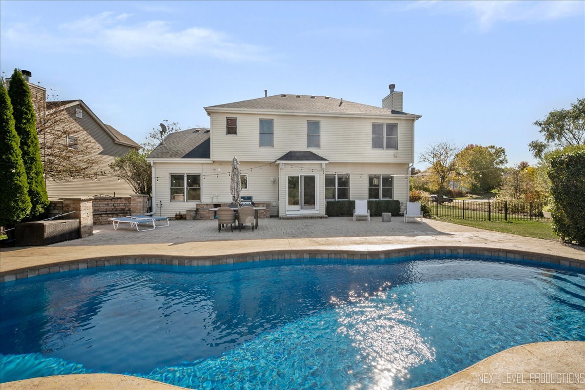 39W252 Bartelt Road Geneva, IL 60134 - Photo 31 of 34 a front view of a house with swimming pool having outdoor seating