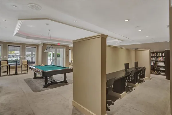 a living room with a table and a chandelier