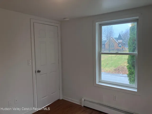 an empty room with window and wall painting