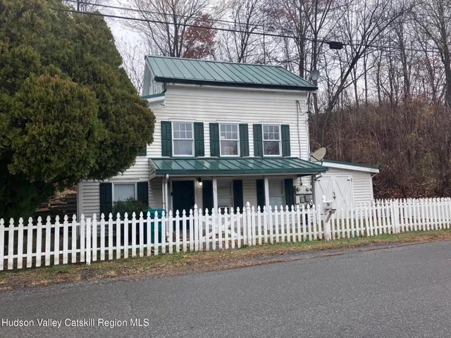 a front view of a house with a fence
