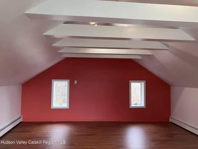 a view of a livingroom with wooden floor and a window