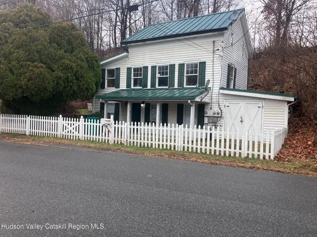 a front view of a house with a fence