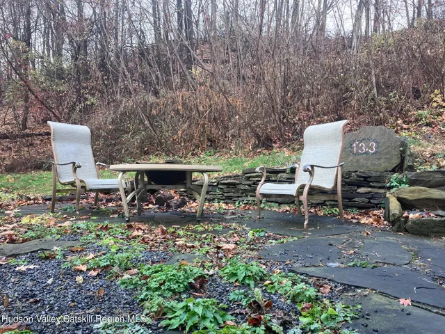 a view of a backyard with sitting area
