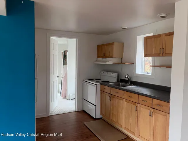 a kitchen with granite countertop a sink and a stove top oven