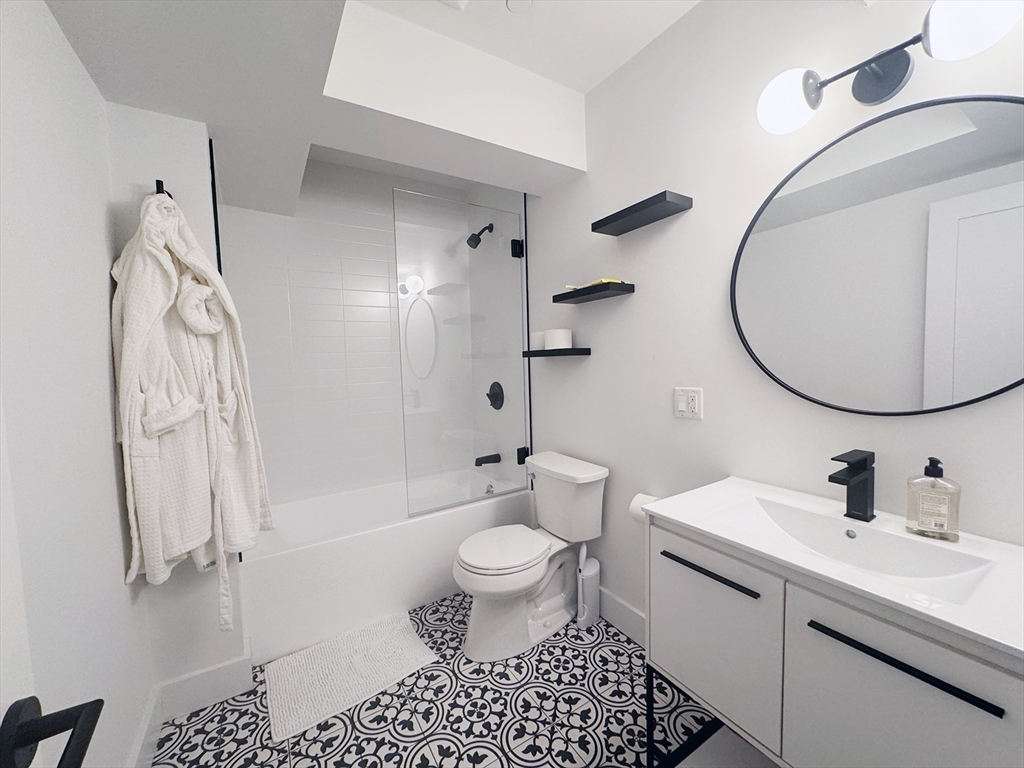 278 Sumner Street, Unit PH Boston, MA 02128 - Photo 19 of 20 a bathroom with a sink a toilet and a mirror