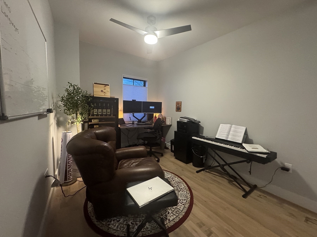 278 Sumner Street, Unit PH Boston, MA 02128 - Photo 6 of 20 a living room with furniture and a wooden floor