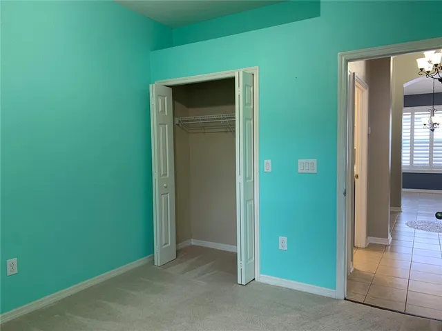 an empty room with wooden floor and closet