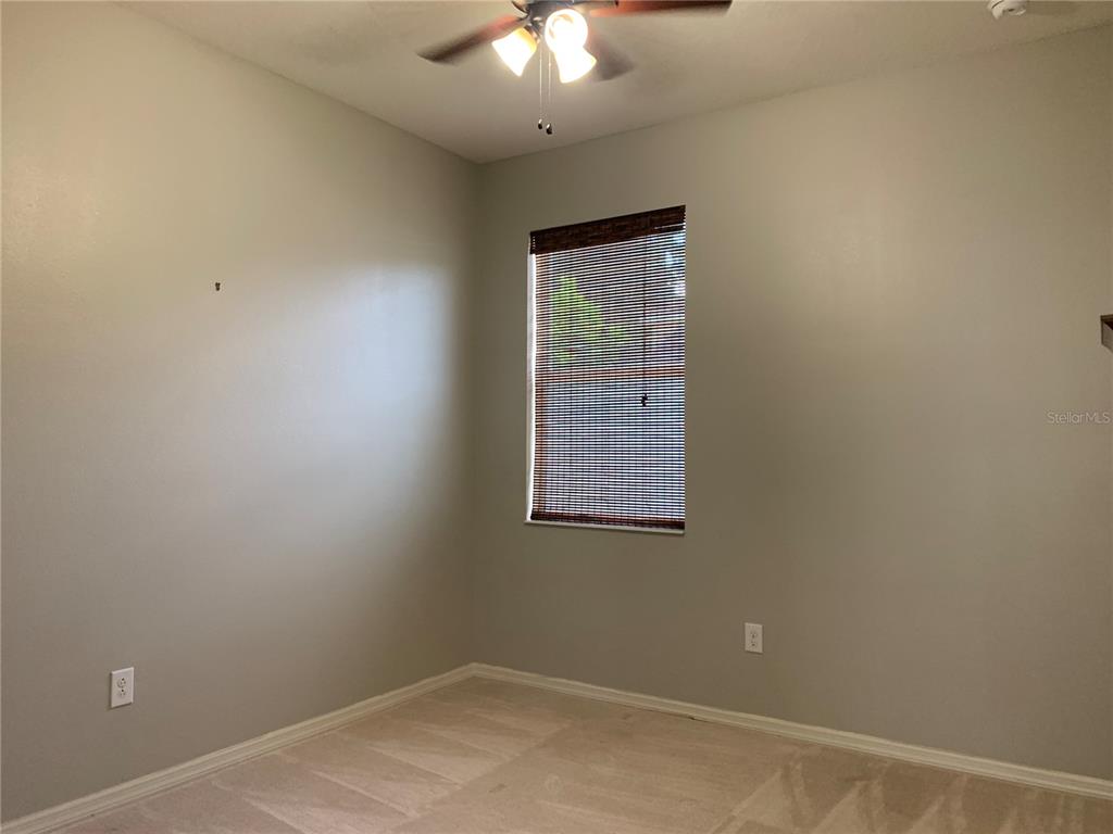 10308 Holland Road Riverview, FL 33578 - Photo 26 of 66 an empty room with a chandelier fan and windows