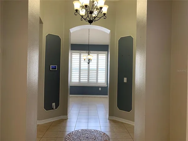 a bathroom with a granite countertop shower a mirror and a sink