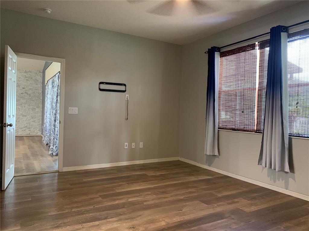 10308 Holland Road Riverview, FL 33578 - Photo 33 of 66 a view of empty room with wooden floor and fan