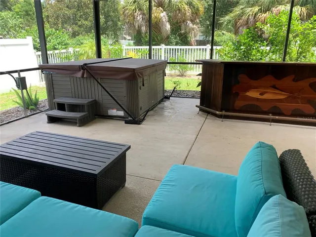 a backyard of a house with table and chairs