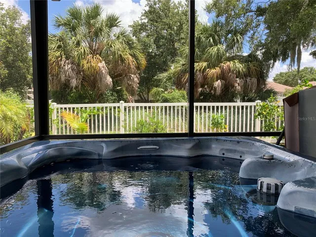 a view of a house with swimming pool and sitting area