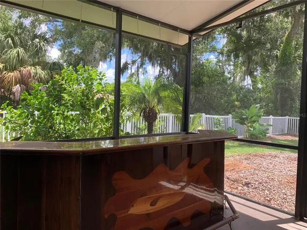 a front view of a house with a yard and potted plants