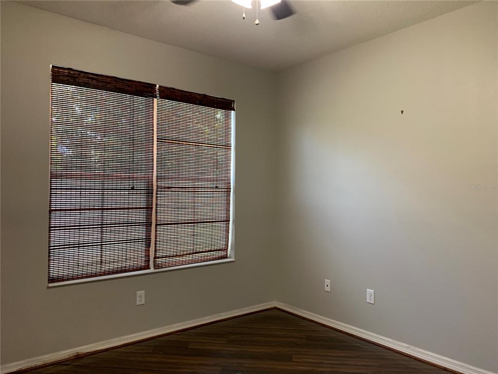 10308 Holland Road Riverview, FL 33578 - Photo 7 of 66 a view of empty room with wooden floor and fan