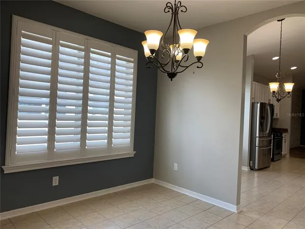 a kitchen with stainless steel appliances granite countertop a stove a refrigerator and a microwave
