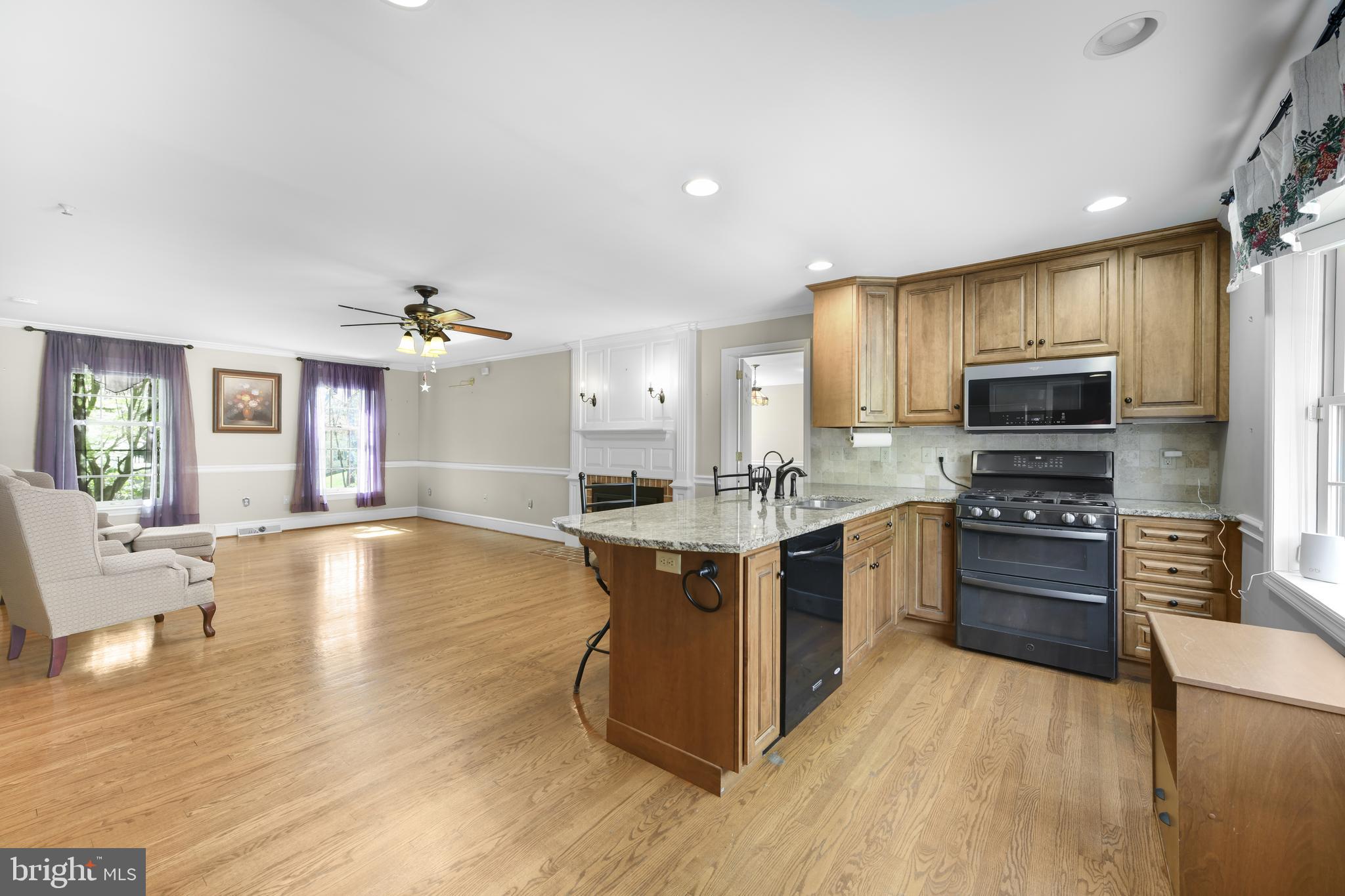22 Fawn Drive Reading, PA 19607 - Photo 25 of 70 a large kitchen with stainless steel appliances a stove a sink dishwasher a microwave oven with a dining table and chairs