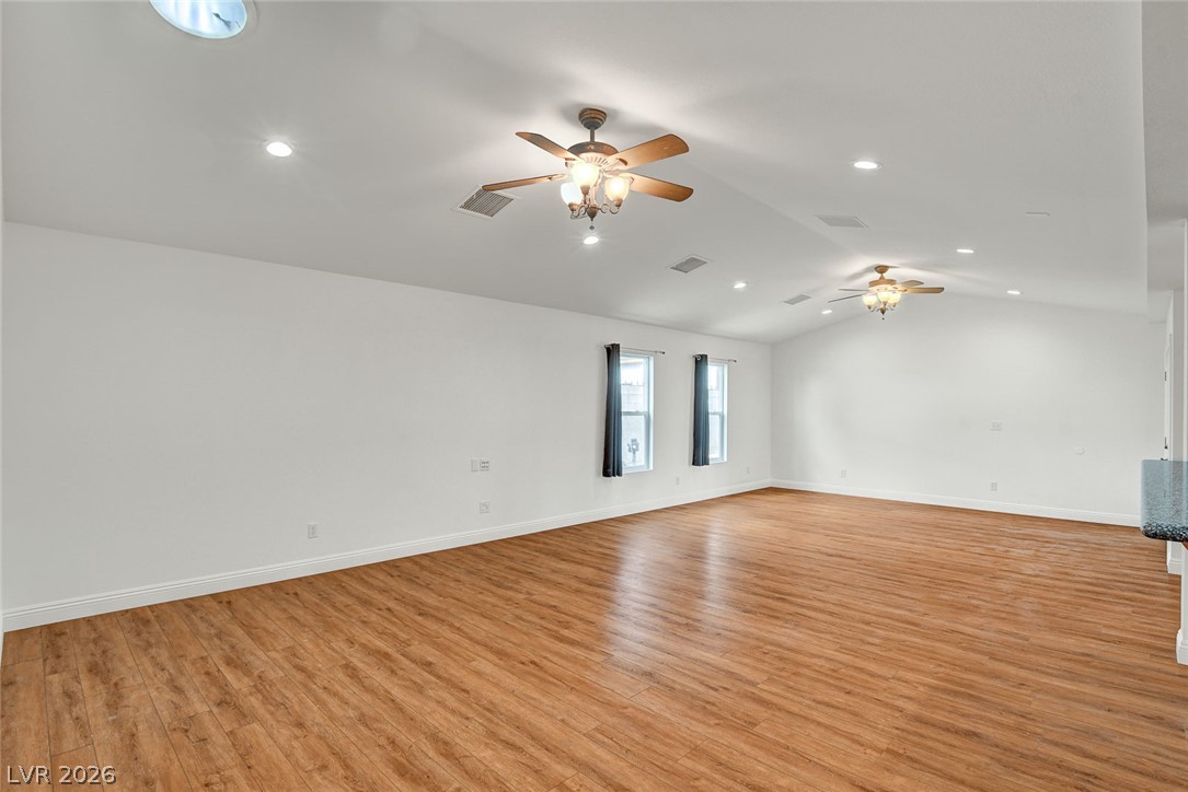 1810 Pinto Road Henderson, NV 89002 - Photo 12 of 53 Vast living area featuring warm wood flooring and abundant recessed lighting.