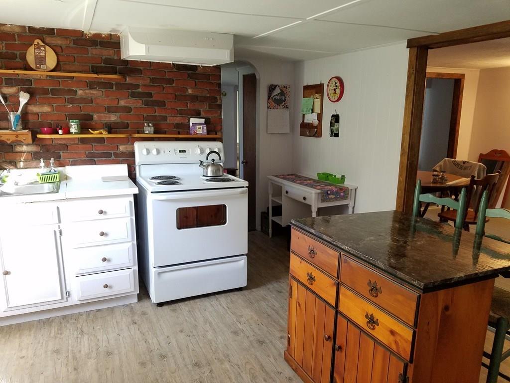 298 Deerfield Street Greenfield, MA 01301 - Photo 3 of 13 a kitchen with stainless steel appliances granite countertop a stove and a sink